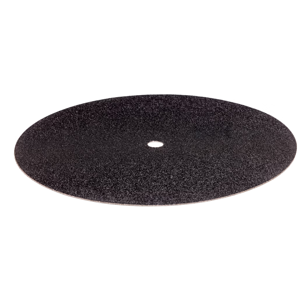 Derendinger_Dummy_56981_Schleifscheibe-gedoppelt_2023.12 Un disque abrasif rond et plat de couleur noire avec un trou central, conçu pour être utilisé avec des outils électriques. La surface semble granuleuse et est destinée à poncer des surfaces pour les préparer à la finition. Le disque est de forme uniforme sans défauts visibles, ce qui indique un processus de fabrication de haute qualité.